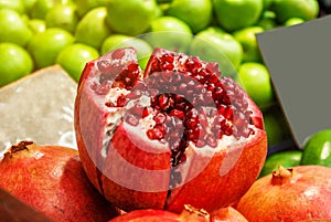 Cut pomegranate fruit on the counter street market. Healthy food, vitamins, weight loss
