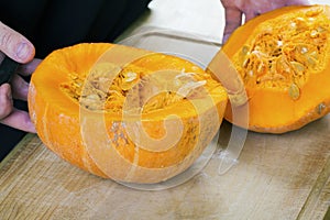 Cut pumpkin on rustic wooden table