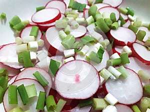 Cut radishes and spring onion for salad