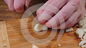 Cut Raw Garlic on a Wood Cutting Board.