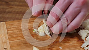 Cut Raw Garlic on a Wood Cutting Board.