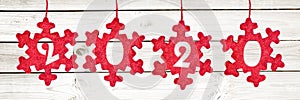 2020 cut in red fabric christmas ornaments hanging on panoramic white planks