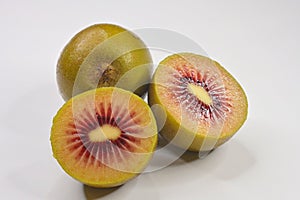 Cut red Kiwifruit or Chinese gooseberry genus Actinidia on white background