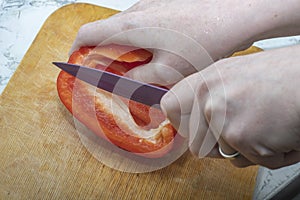 cut red pepper with a knife