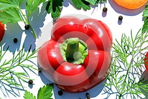 Cut red, sweet pepper lies on a white background