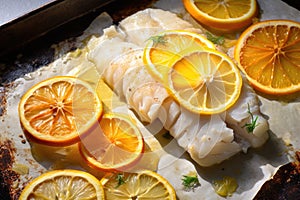 cut-through shot of baked cod, lemon pieces visible inside