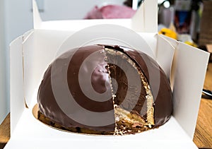 Cut slice of Delicious Bombe au chocolat translated chocolate bomb on the wooden