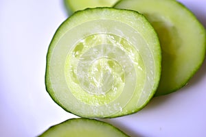 Cut slice of fresh and delicious cucumber close up