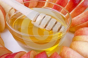 Cut into slices of apples with a bowl of honey