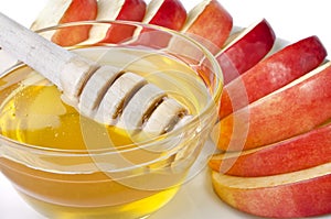 Cut into slices of apples with a bowl of honey