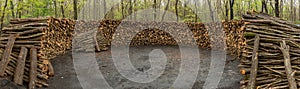 Cut and stacked logs for making charcoal