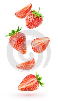 Cut strawberries levitation isolated on white photo