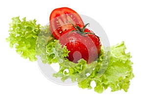 Cut tomato on sheet of the salad