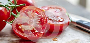 Cut Truss Tomatoes on Board with Knife