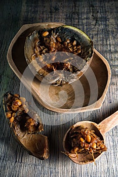 Cut up borojo fruit on rustic wood surface