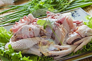 Cut up raw whole chicken in a plate