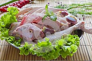 Cut up raw whole chicken in a plate