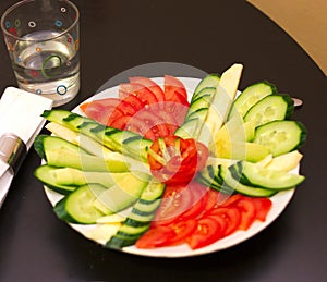 Cut vegetables tomatoes cucumbers on the plate