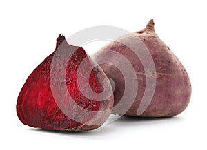 Cut and whole beets on white background