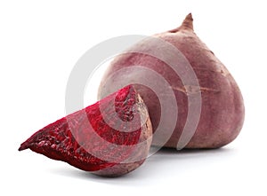 Cut and whole beets on white background