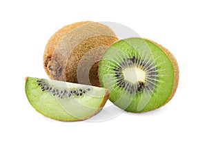 Cut and whole fresh kiwis on background