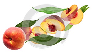 Cut and whole fresh ripe peaches with green leaves falling on white background