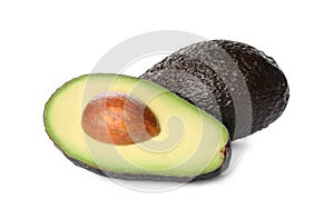 Cut and whole ripe avocadoes on white background