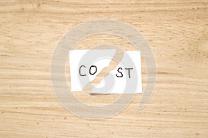 Cut the word cost concept for recession or credit crisis on wood.