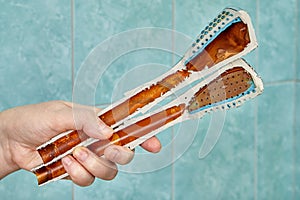 Cutaway old shower head reveals rust inside