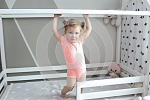 Cute 2 years little girl in her white bed at home