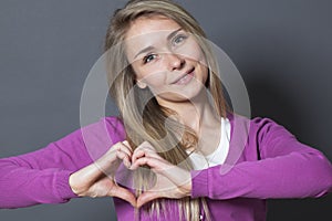 Cute 20s woman showing heart shape with hands