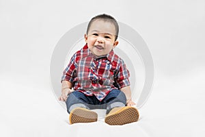 Cute 6-7 months little asian baby boy in casual outfit and baby boots sitting on white blanket cool and happily at home,Stylish