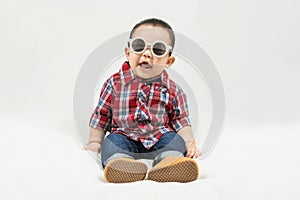 Cute 6-7 months little asian baby boy in casual outfit and baby boots sitting on white blanket cool and happily at home,Stylish