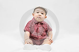 Cute 6-7 months little asian baby boy in casual outfit and hat sitting on white blanket cool and happily at home,Stylish