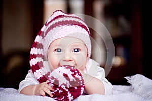 Cute 6 month baby holding a bobble in her hands