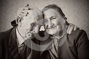 Cute 80 plus year old married couple posing for a