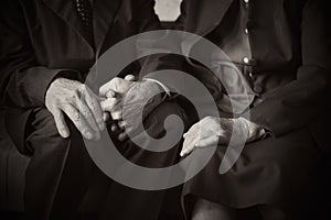 Cute 80 plus year old married couple posing for a portrait in their house. Love forever concept