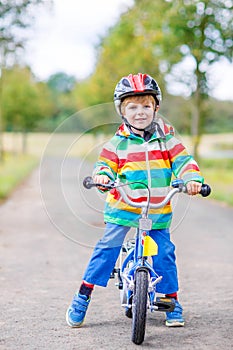Cute active little boy riding on bike