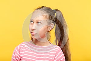 Cute adolescent girl looking up sideways portrait