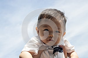 Cute and adorable Asian Chinese baby boy carry up by mother