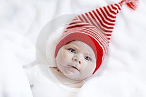 Cute adorable baby child with Christmas winter cap on white background