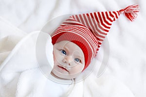 Cute adorable baby child with Christmas winter cap on white background