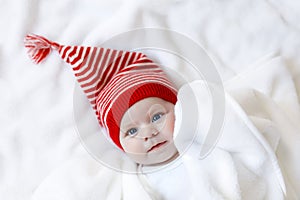 Cute adorable baby child with Christmas winter cap on white background