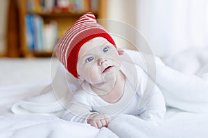 Cute adorable baby child with Christmas winter cap on white background