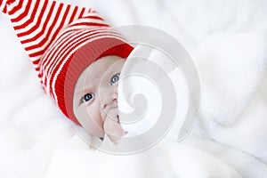 Cute adorable baby child with Christmas winter cap on white background