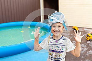 Cute adorable caucasian blond little girl making experiment try diving in pool with full face snorkel mask in inflatable