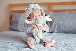 Cute adorable Caucasian blonde smiling baby girl with blue eyes