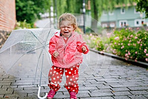 Cute adorable crying sad toddler girl on a walk. Little baby child going for walk with parents. frustrated healthy kid