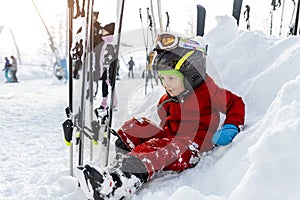 Cute adorable little kid boy enjoy having fun sledging down hill of snow heap snowdrift at alpine mountain skiing resort