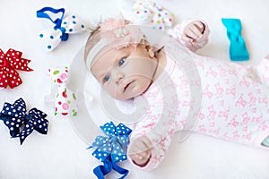 Cute adorable newborn baby child with colorful bows